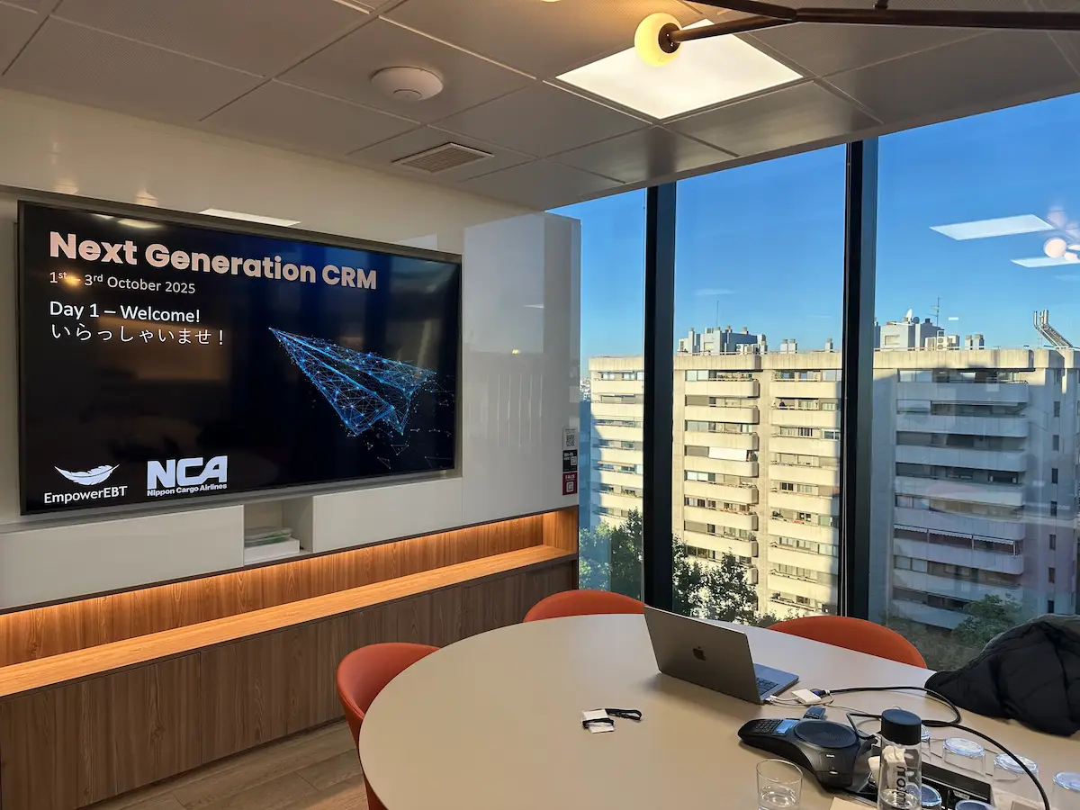 Classroom view of an Empower.aero Nippon Cargo Airlines next generation CRM workshop on screen, with glass windows overlooking Madrid